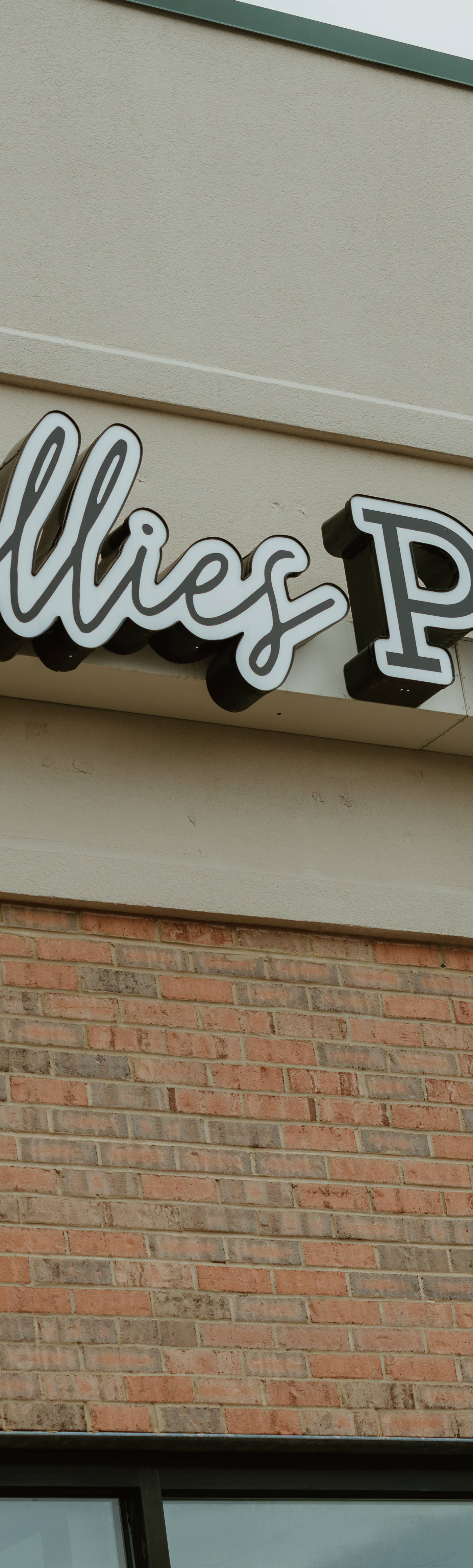 The Catalillies Play Café sign above the storefront in James York Plaza, Williamsburg